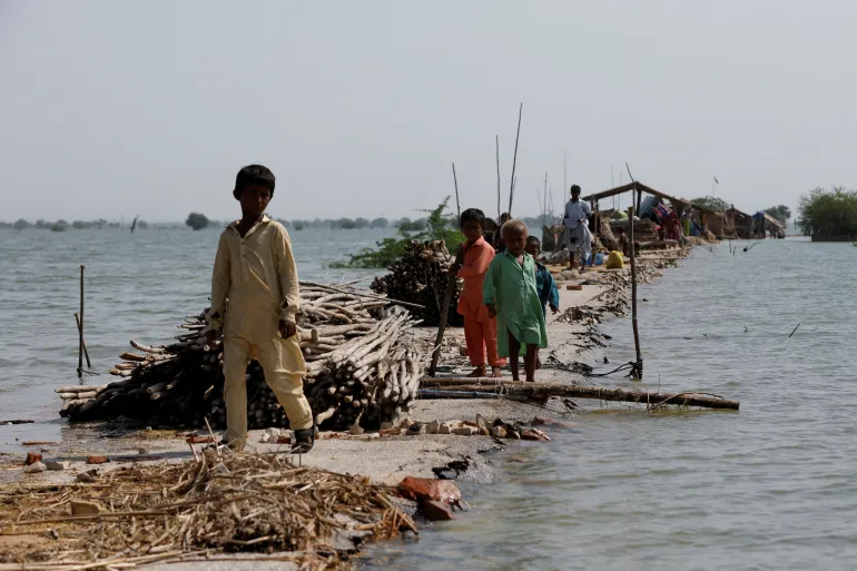 An image of people moving out of flooded areas.
