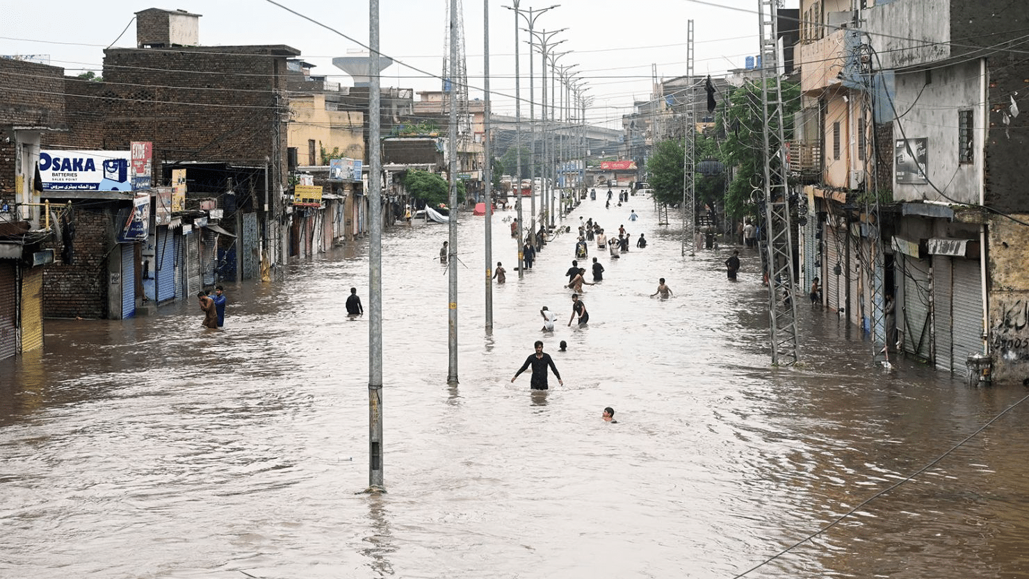 People and children waking through the water , too much water due to climate change