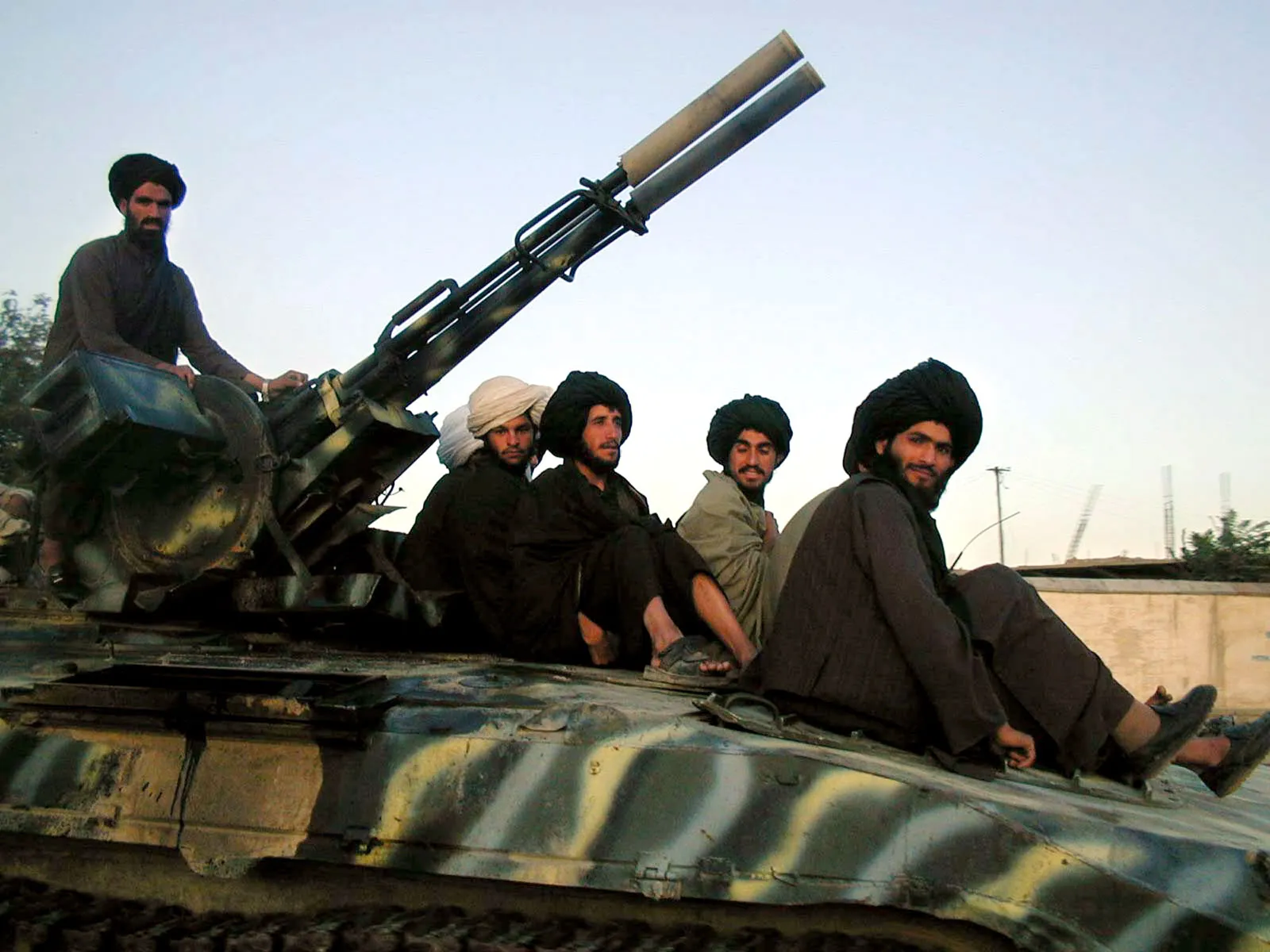 taliban sitting on the tank