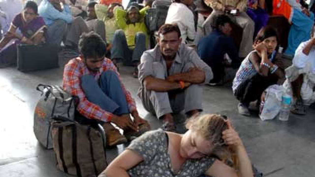 A female tourist sitting on a railway station