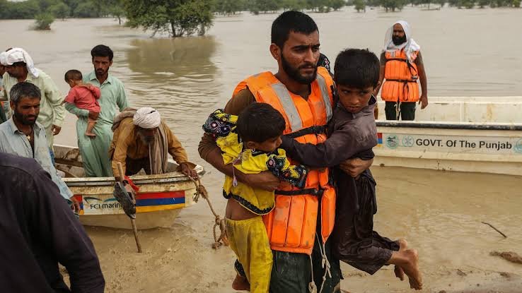 A rescue worker helping people in flood area.
