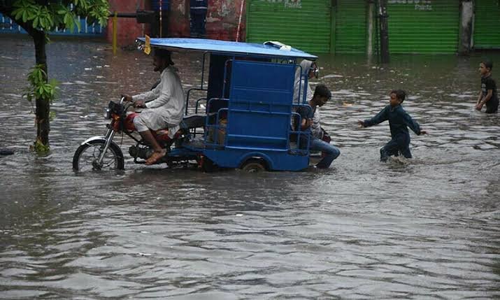  A Rikshaw can be seen half submerged in water due to heavy rains in Lahore. 
