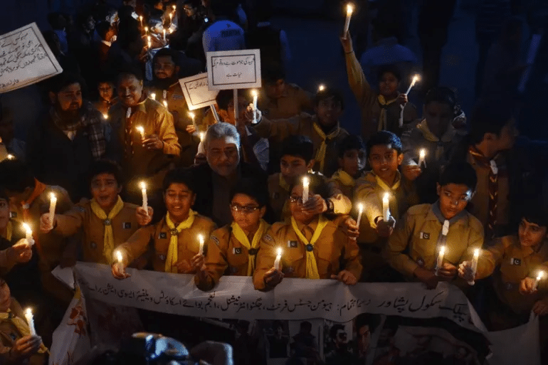 A Nation’s Struggle for Peace: Terrorism’s Toll on Pakistan 1 Students demonstrating with candles in memory of APS martyrs