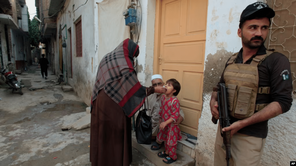 A Nation’s Struggle for Peace: Terrorism’s Toll on Pakistan 2 A polio worker on duty along with police security person.