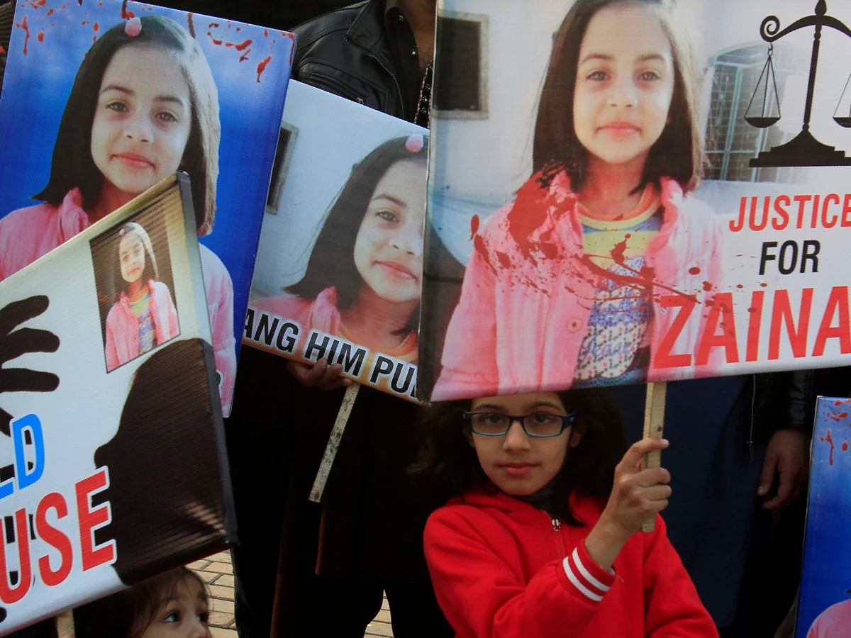 Girls hold placards at a protest in Lahore against the rape and murder of Zainab Ansari.