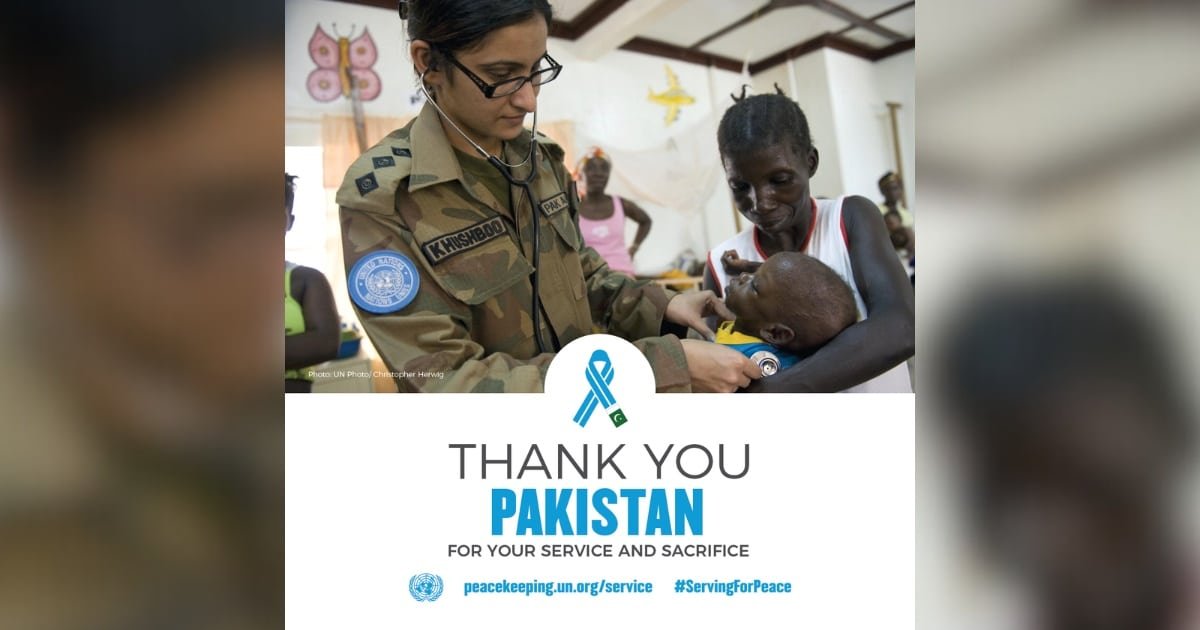A Pakistani lady doctor in a UN mission treating an African Child