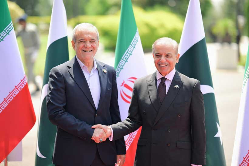 President of Iran Masoud Pezeshkian and Prime Minister of Pakistan Shahbaz Sharif smiling and Handshake 