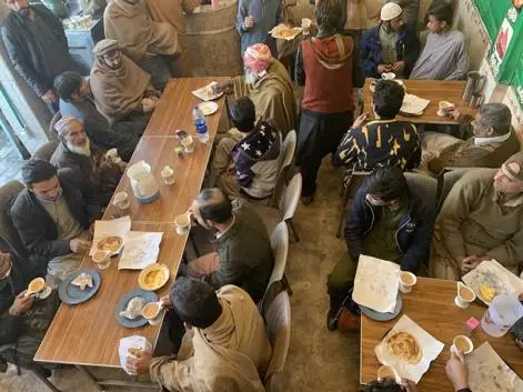 The Cultural Legacy of Pakistani Tea Houses: Poetic and Literary Bliss 6 People sitting at a chai hotel