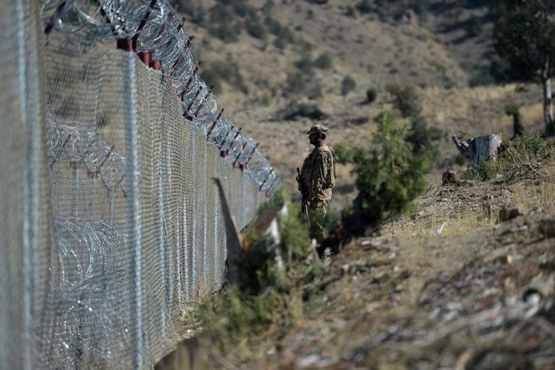 A Pak army soldier stands guard at the fenced Durand line