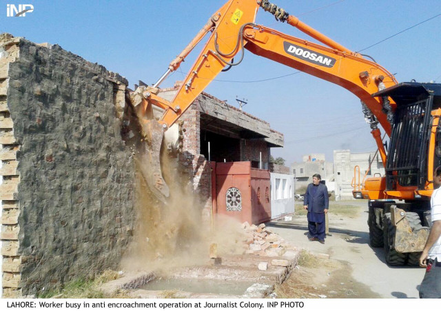 Workers busy in anti-encroachment operation at Journalist Colony