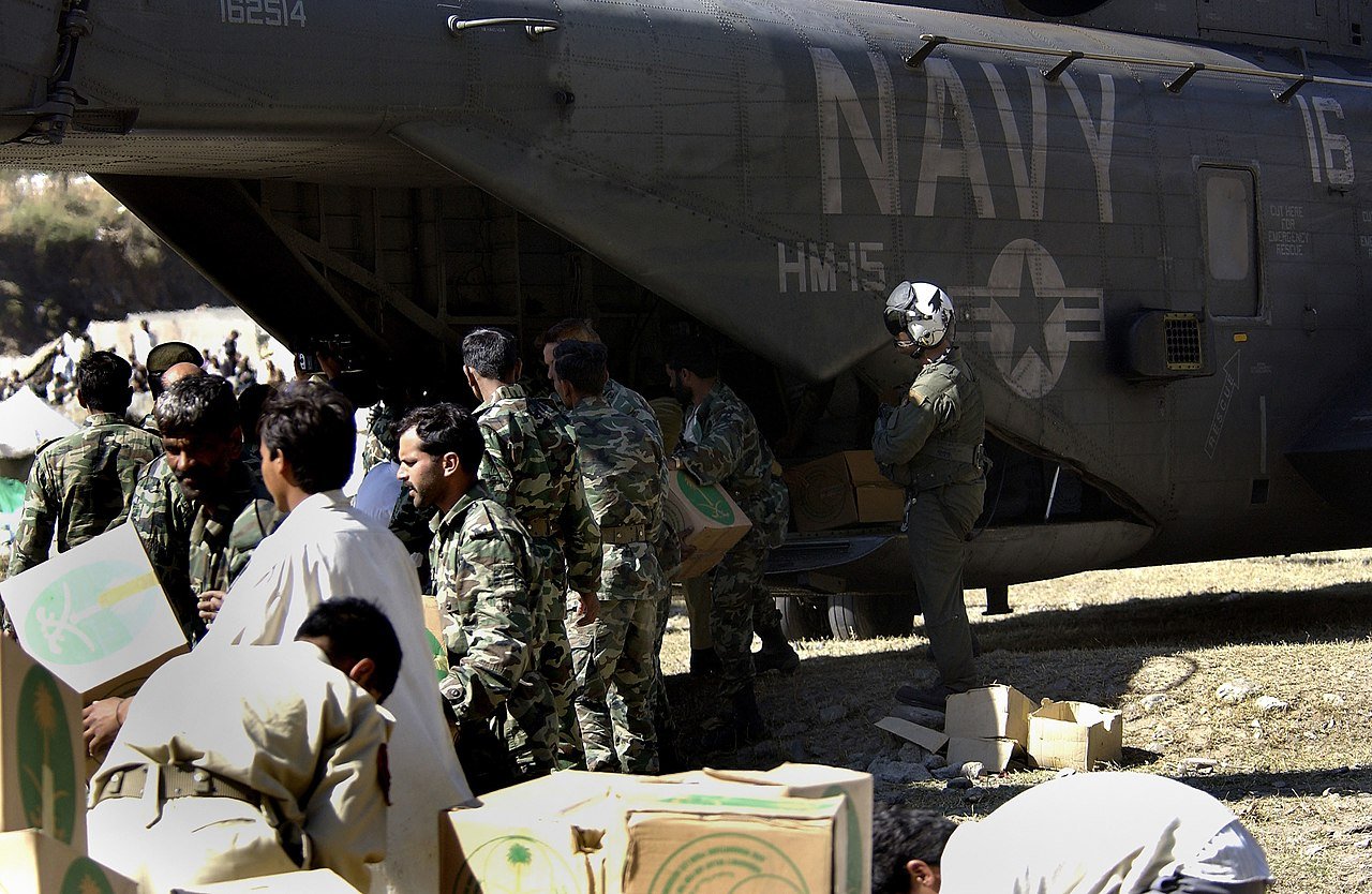 Pak Army soldiers unloading relief supplies from US helicopter