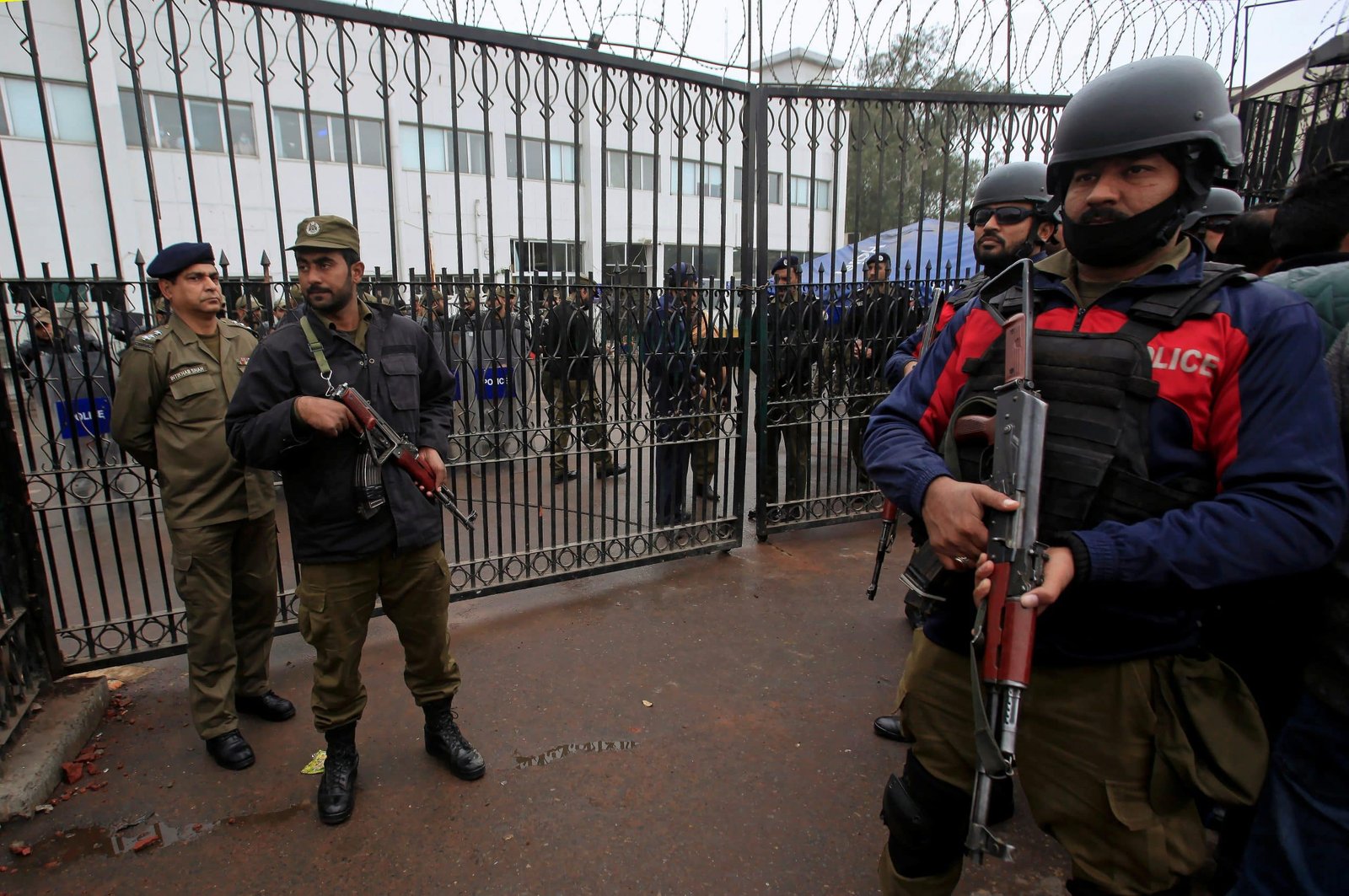 Police personnel in front of a building New 5-year internal security policy aims to centralize Pakistan's police operations